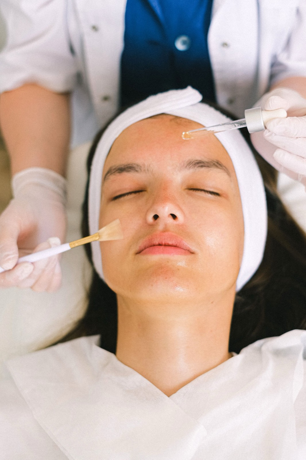 A skincare treatment being carried out in a calm, clinical setting.